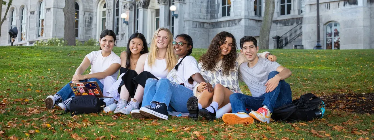 A group of people sitting outside a building.